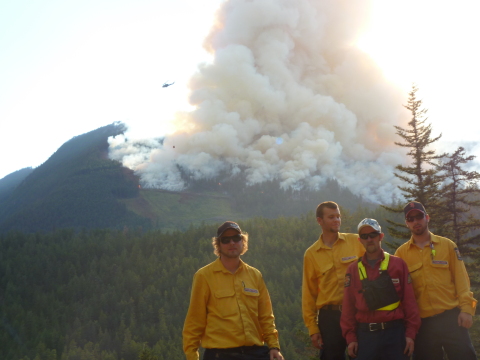 Firestorm Team Posing Behind Fire