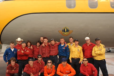 Firestorm Team posing behind airplane